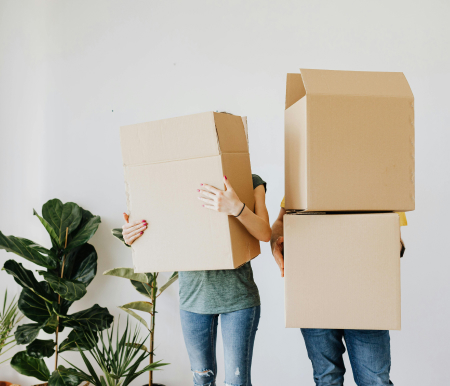 Two people holding boxes