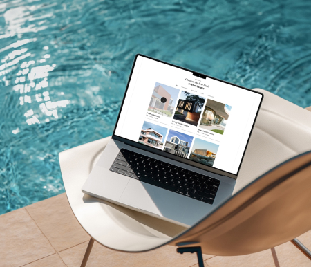 MacBook laying on the chair by the pool