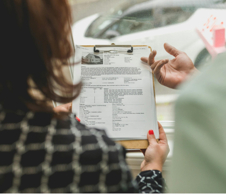 Woman holding house listing
